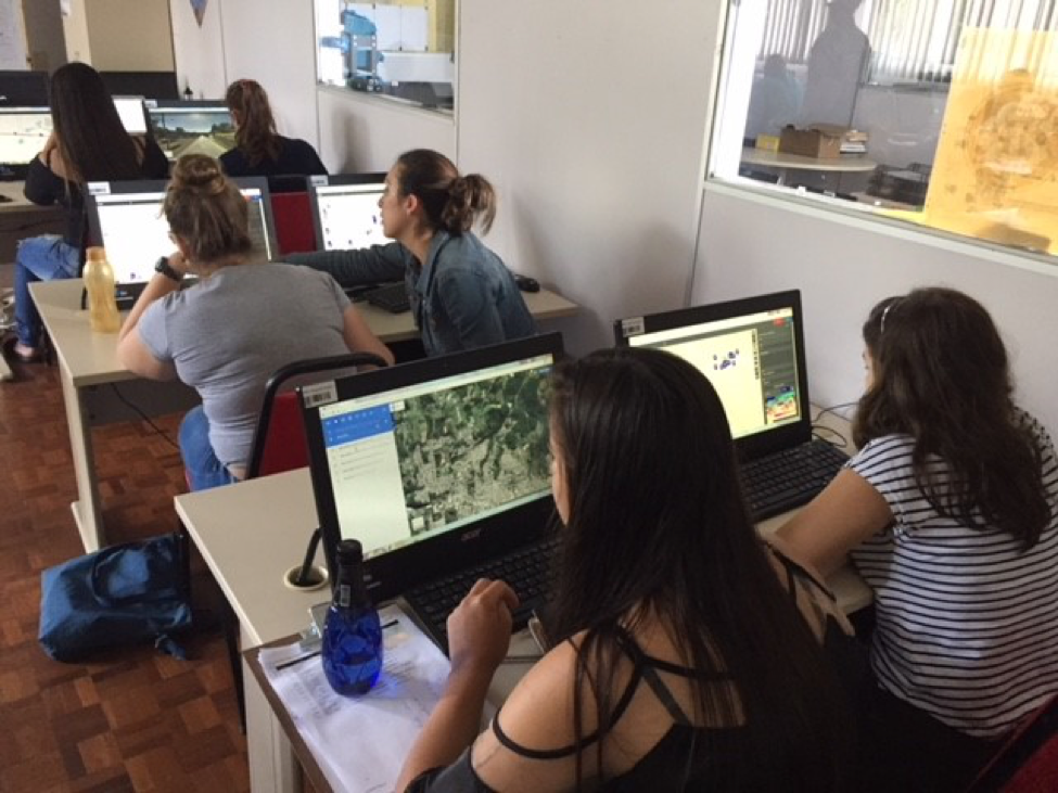 Picture of students using desktop computers to edit data.
